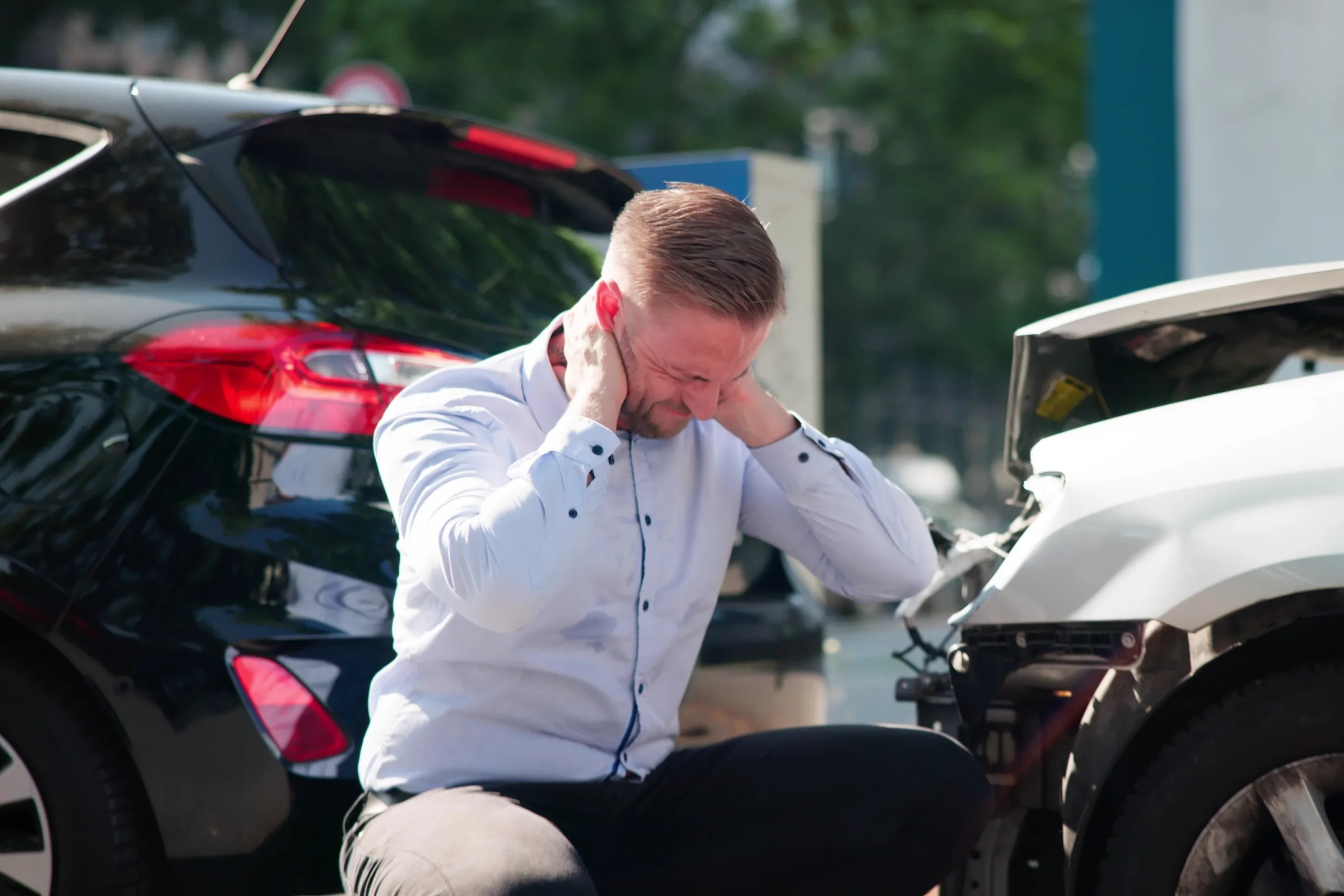 The roadside moment after a rear-end collision, before the neck has caught up